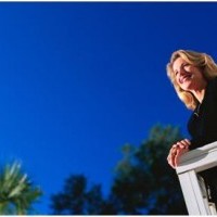 woman on deck with blue sky above