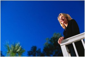 woman on deck with blue sky above