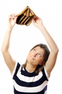 woman holding up an empty file extender for coupons or budgetting