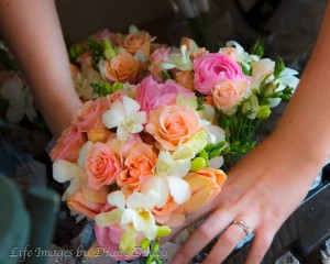 woman holding wedding floral arrangement