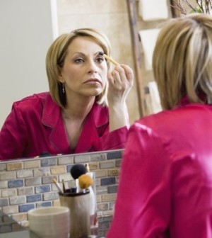 woman putting eye makeup on