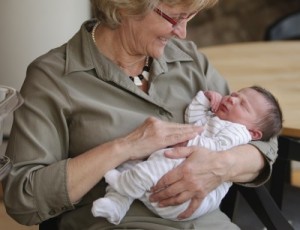 grandma with newborn in arms