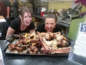 women looking at big plate of beef bones