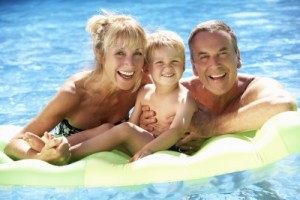 mature couple with child in pool