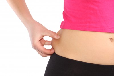 woman pinching her fat on hip