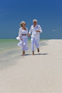 mature couple running on beach