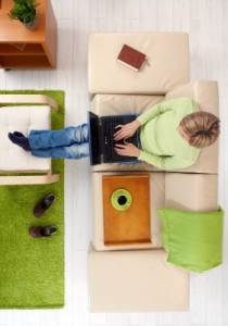 woman setting on couch with laptop