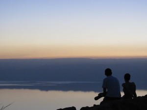couple sitting on banks of the Dead Sea
