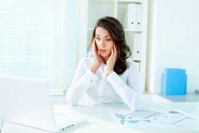 woman upset working at computer