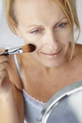 mature woman with makeup brush