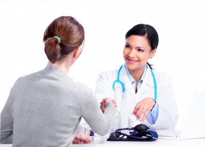 woman shaking her healthcare provider