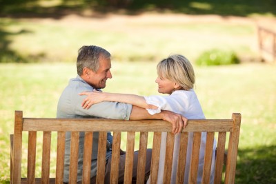 happy couple setting on bench