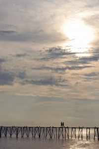 a couple walking on a dock