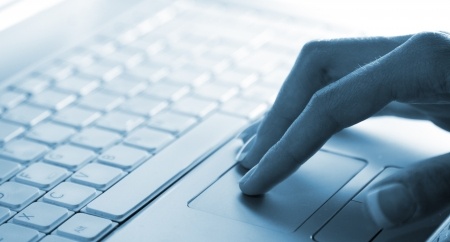 woman's hand on laptop keys