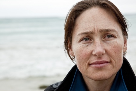 woman on beach sad expression