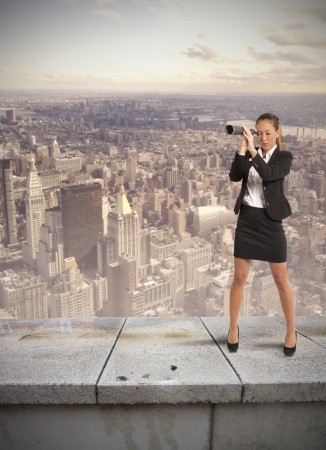 woman with telescope standing on building