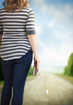 woman with book in hand on road