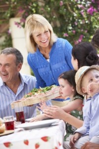 woman serving meal to family
