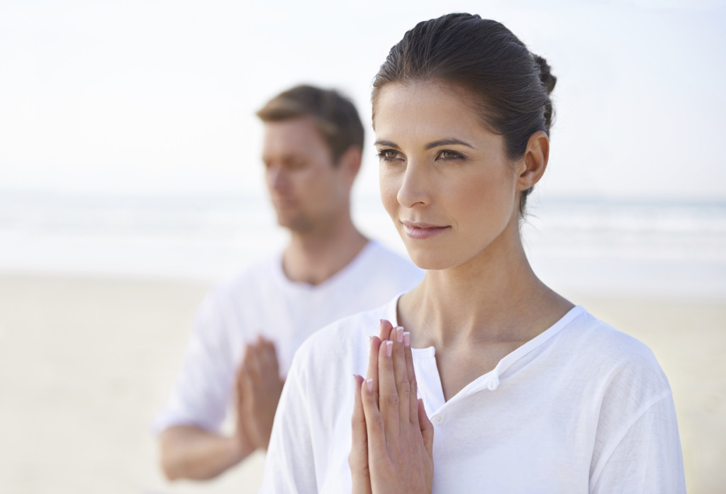 woman and man in yoga position