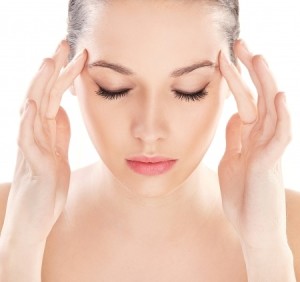 woman touching her temples of head