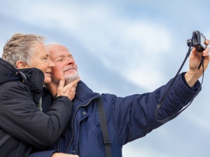 a mature couple taking a picture selfie