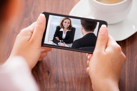 photo of woman holding smartphone