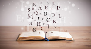 letters floating above open book