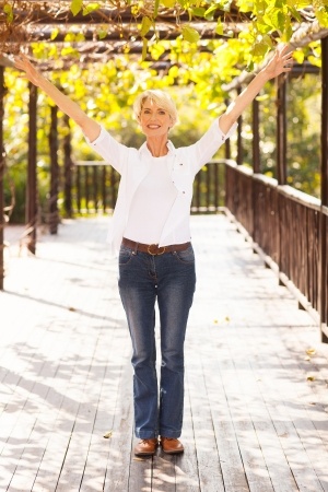 happy woman holding hands up