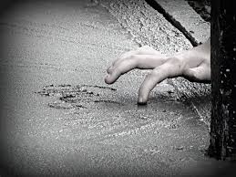 child writing in wet cement