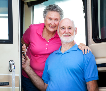older couple in front of RV