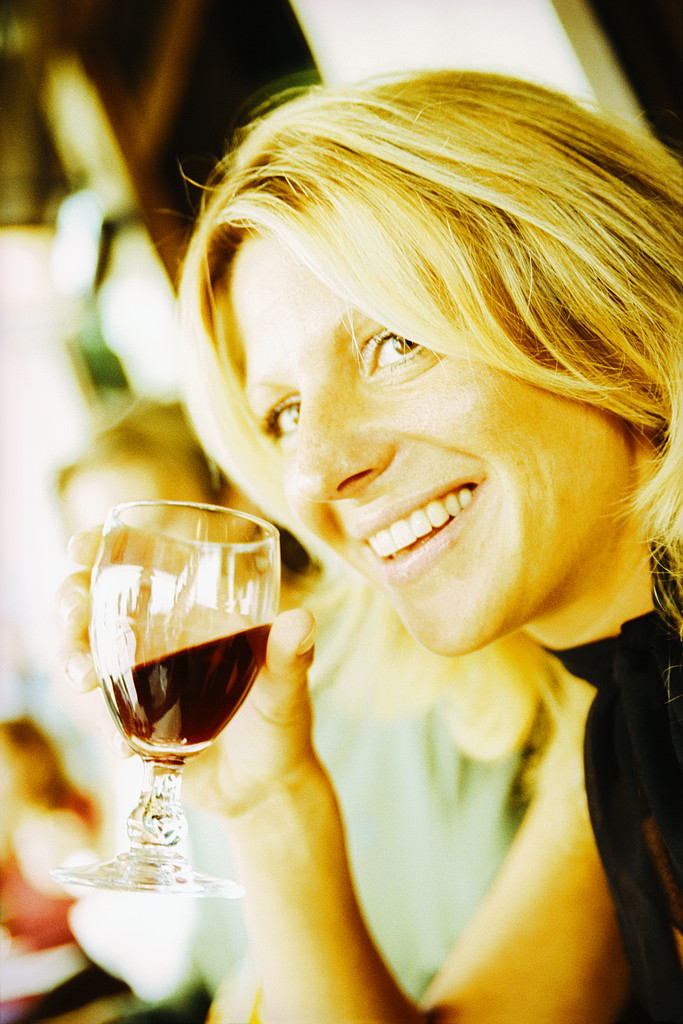 mature woman holding glass of wine