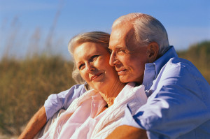 couple embraced sitting on beach