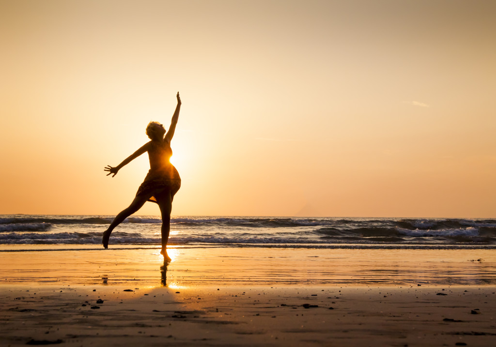 woman dancing on beach