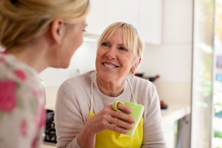 two women talking in kitchen