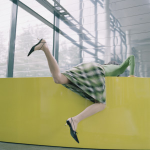 woman climbing over wall