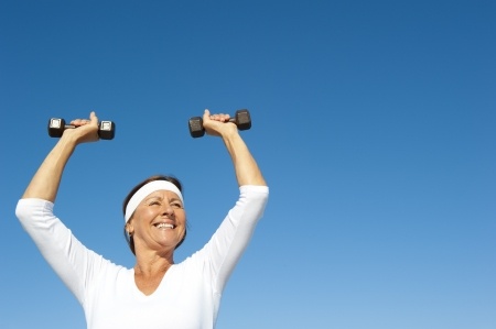 mature woman lifting hand weights