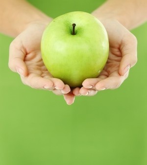 someone holding a green apple