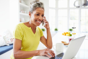 senior woman on phone at computer
