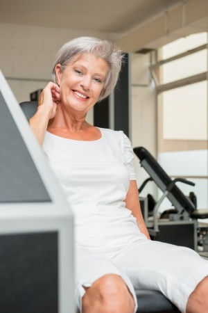 mature woman working on exercise equipment