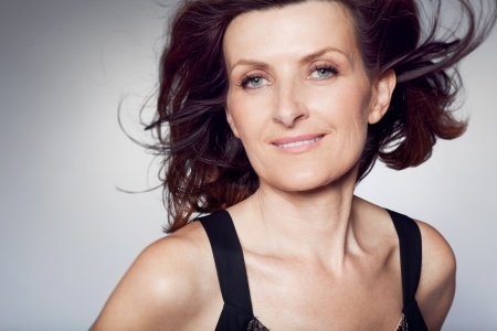 attractive mature woman with dark hair blowing