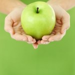 hands holding apple