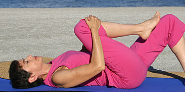 woman stretching on exercise mat