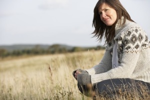 woman outside in field thinking