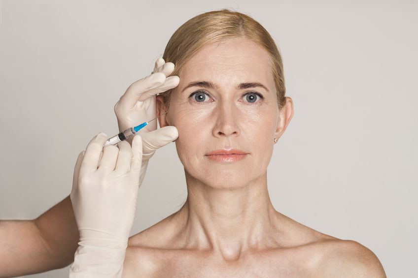 Plastic Surgery. Middle Aged Woman Receiving Botox Injection